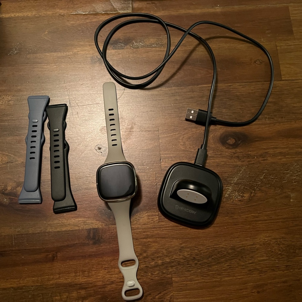 Fitbit sense, charger, three bands